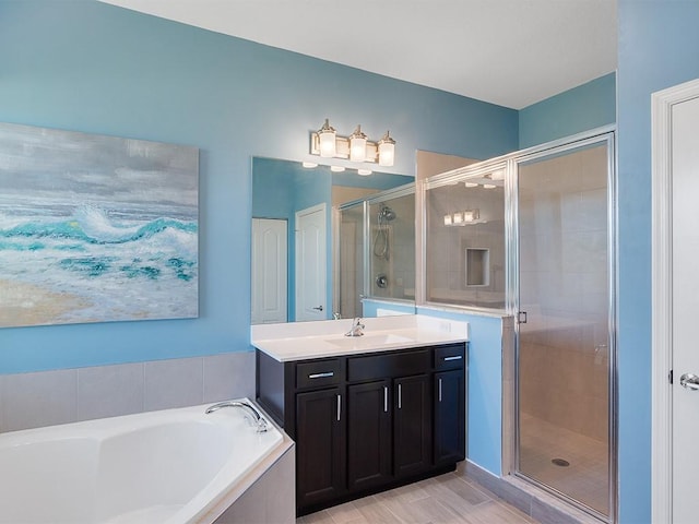 bathroom with vanity and separate shower and tub