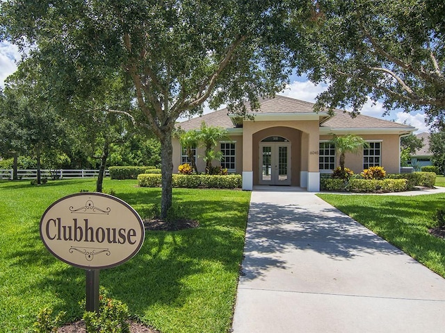 view of front of property featuring a front yard and french doors