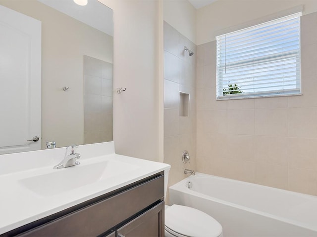 full bathroom featuring vanity, toilet, and tiled shower / bath