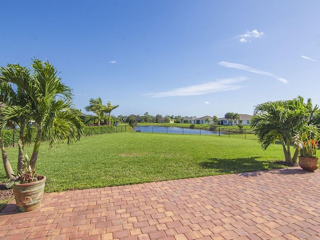 view of community featuring a lawn and a water view