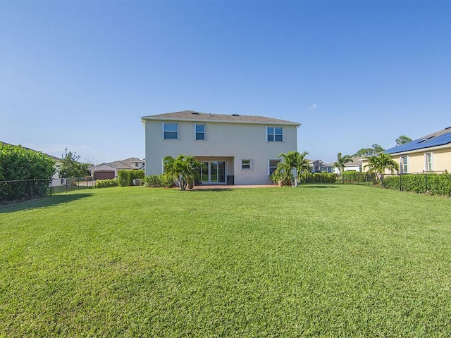 back of property featuring a yard