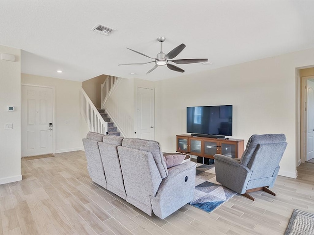 living room featuring ceiling fan and light hardwood / wood-style floors