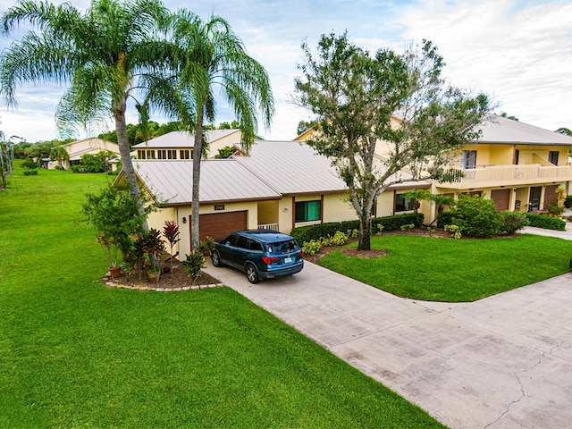 view of front facade with a garage and a front lawn