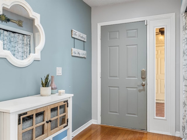 foyer with hardwood / wood-style flooring and a textured ceiling