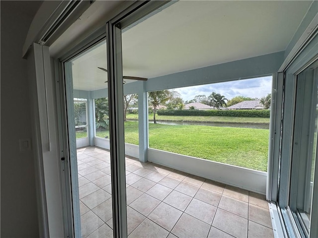 doorway to outside with light tile patterned floors and a wealth of natural light