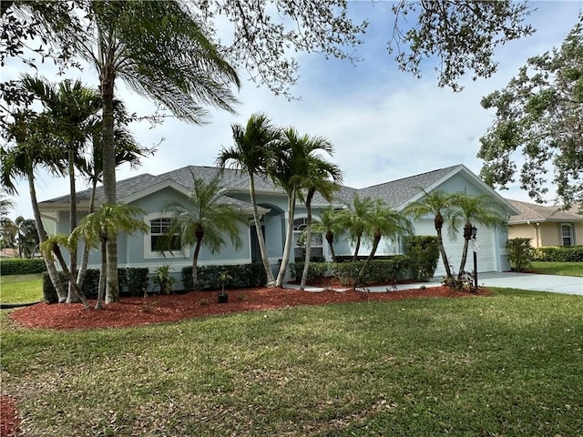 single story home featuring concrete driveway, an attached garage, and a front lawn