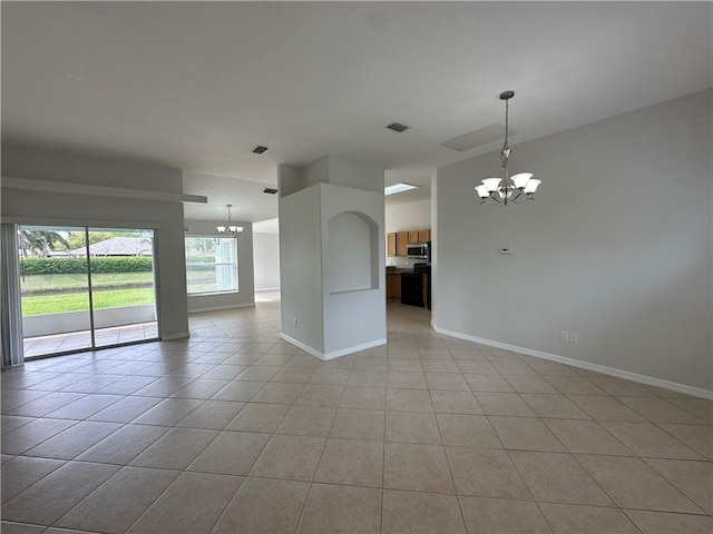 unfurnished room featuring baseboards, a notable chandelier, and light tile patterned flooring