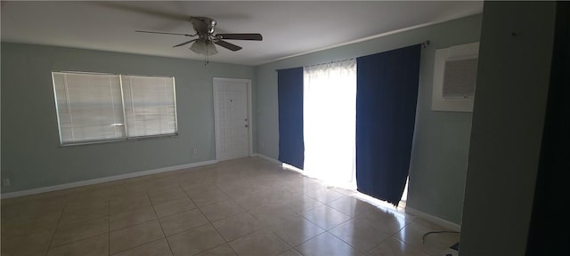 tiled spare room with ceiling fan