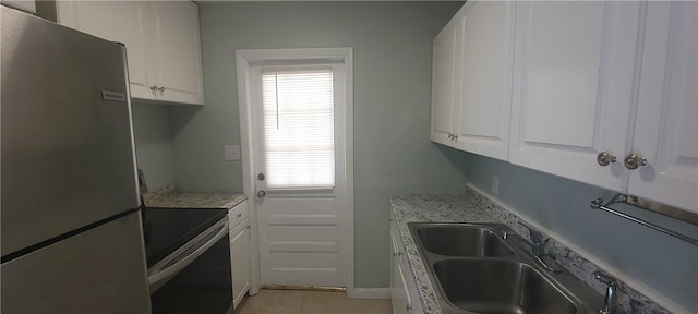 kitchen with appliances with stainless steel finishes, white cabinetry, and sink