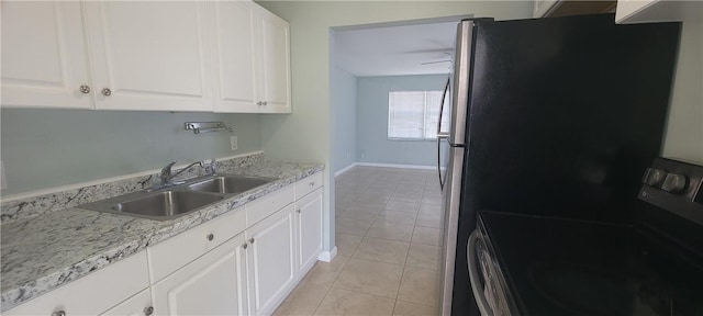 kitchen with white cabinets, sink, light stone countertops, black range with electric cooktop, and light tile patterned flooring