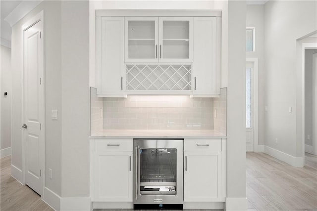 1820 Arawak St, Vero Beach, FL 32967 - kitchen featuring ornamental molding, white cabinetry, wall chimney range hood, and stainless steel appliances
