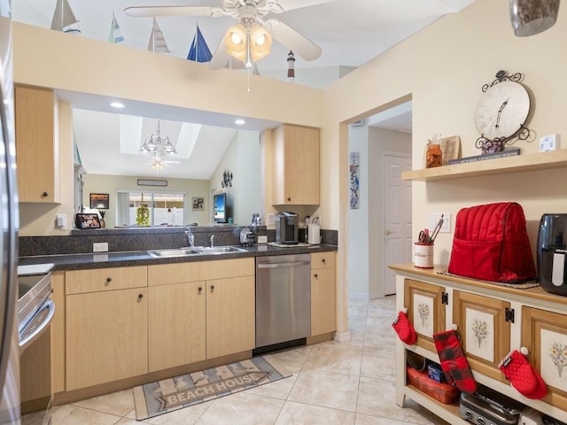 497 7th St, Vero Beach, FL 32962 - kitchen with stainless steel dishwasher, a ceiling fan, a sink, light brown cabinetry, and dark countertops