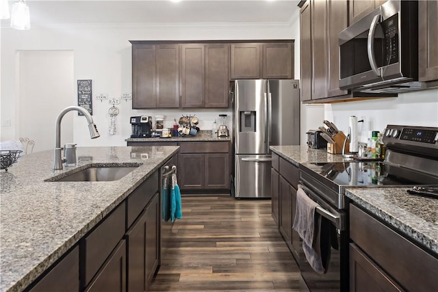 4308 Lago Vista Dr, Sebastian, FL 32976 - kitchen with stainless steel appliances, a sink, dark brown cabinetry, dark wood-style floors, and crown molding