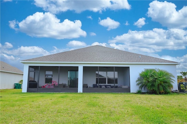 4308 Lago Vista Dr, Sebastian, FL 32976 - back of house with a sunroom, a yard, stucco siding, and a shingled roof