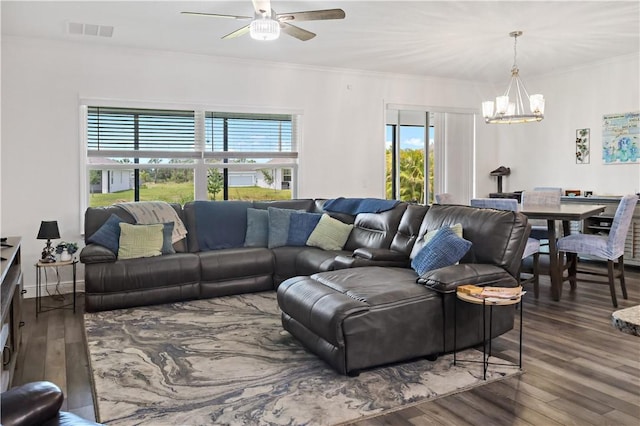 4308 Lago Vista Dr, Sebastian, FL 32976 - living room with a chandelier, wood finished floors, ceiling fan, and crown molding