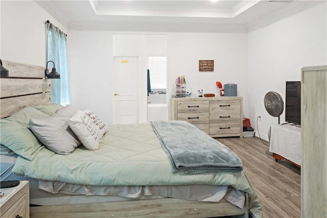 4308 Lago Vista Dr, Sebastian, FL 32976 - bedroom featuring a raised ceiling, crown molding, wood finished floors, and baseboards