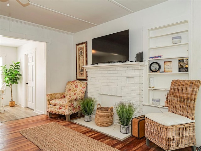 2047 38th Ave, Vero Beach, FL 32960 - living room featuring wood finished floors, a fireplace, and built in features