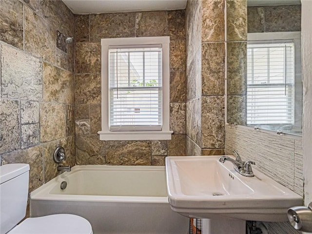 2047 38th Ave, Vero Beach, FL 32960 - bathroom with healthy amount of natural light, tile walls, and shower / tub combination