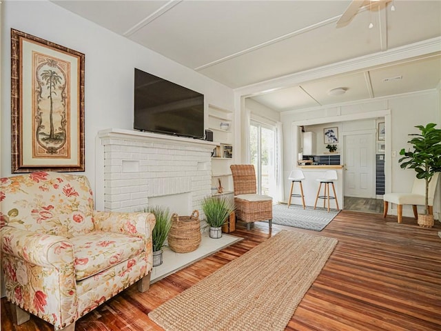 2047 38th Ave, Vero Beach, FL 32960 - living area with wood finished floors, a brick fireplace, and a ceiling fan
