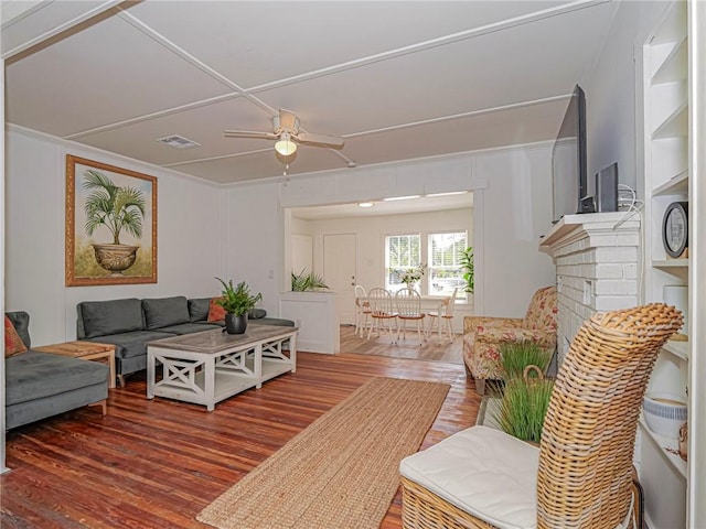 2047 38th Ave, Vero Beach, FL 32960 - living area with wood finished floors, ceiling fan, a brick fireplace, and ornamental molding