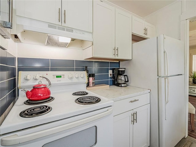 2047 38th Ave, Vero Beach, FL 32960 - kitchen featuring white appliances, under cabinet range hood, decorative backsplash, and white cabinets
