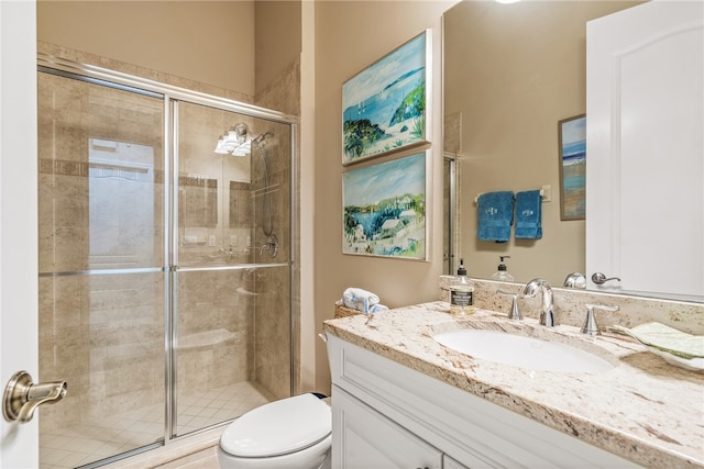 bathroom with vanity, toilet, and an enclosed shower