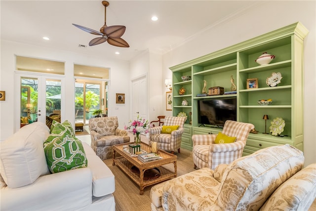 living room with ceiling fan and crown molding