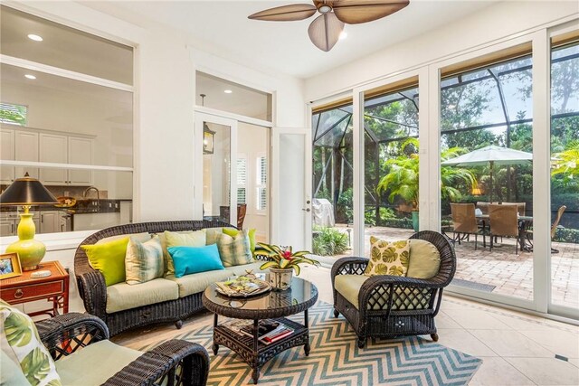 sitting room with ornate columns, ceiling fan, and crown molding