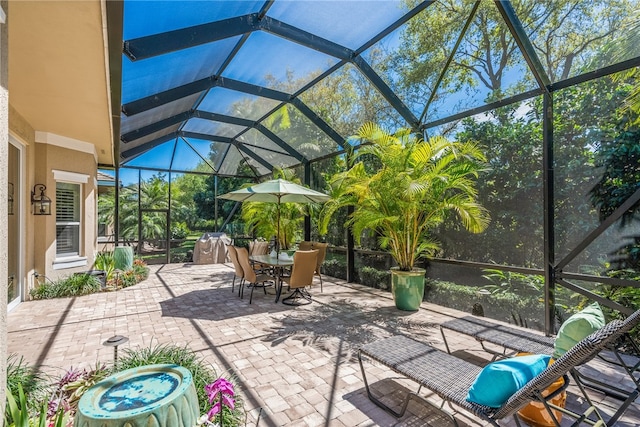 view of patio featuring a lanai