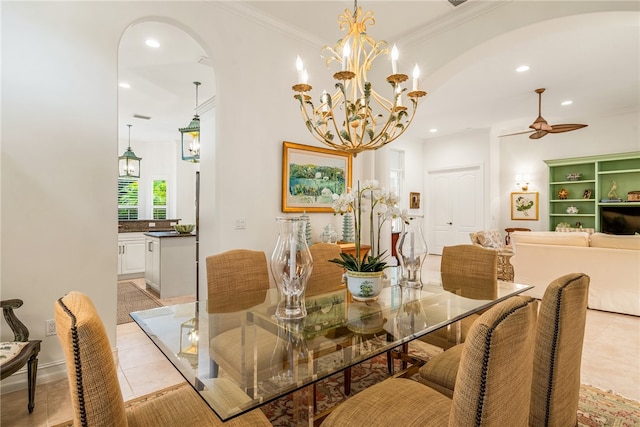 tiled dining room featuring ornamental molding and ceiling fan with notable chandelier