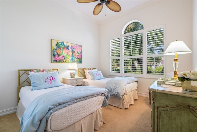 bedroom featuring ornamental molding, light carpet, and ceiling fan