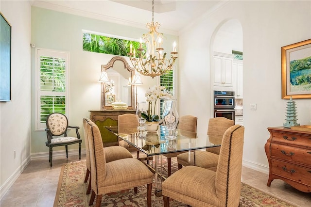 1217 Riverwind Cir, Vero Beach, FL 32967 - dining space featuring a chandelier, ornamental molding, light tile patterned flooring, arched walkways, and baseboards