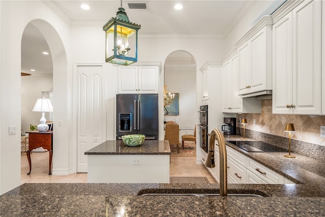 kitchen with white cabinetry, ornamental molding, dark stone countertops, and black appliances