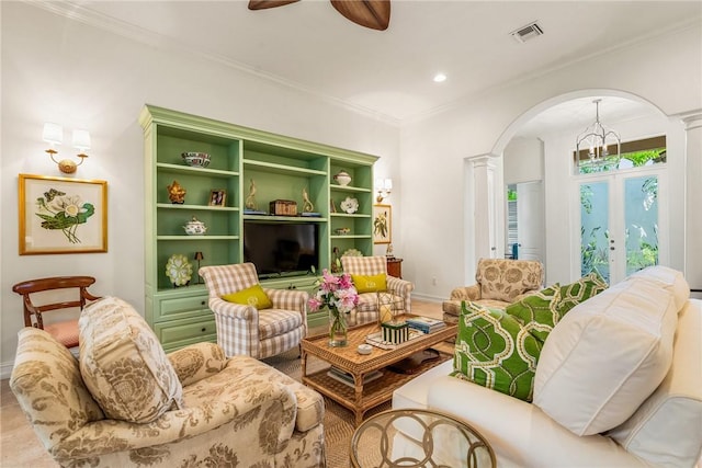 living room featuring crown molding, decorative columns, and ceiling fan