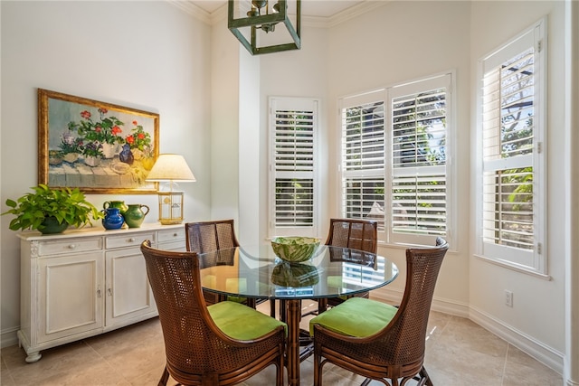 tiled dining space featuring ornamental molding