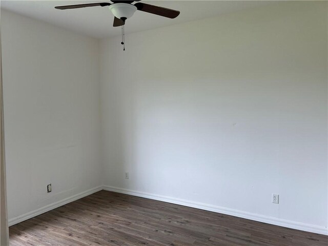 8475 101st Ct, Vero Beach, FL 32967 - empty room with dark wood finished floors and ceiling fan