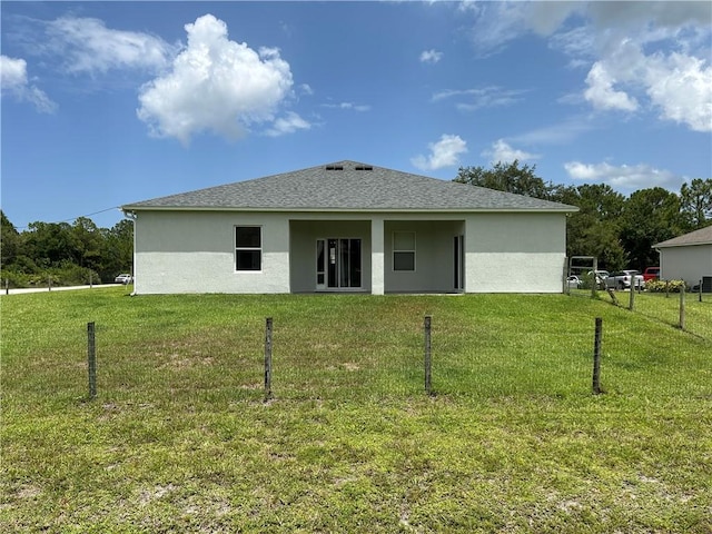 8475 101st Ct, Vero Beach, FL 32967 - back of house with stucco siding and roof with shingles