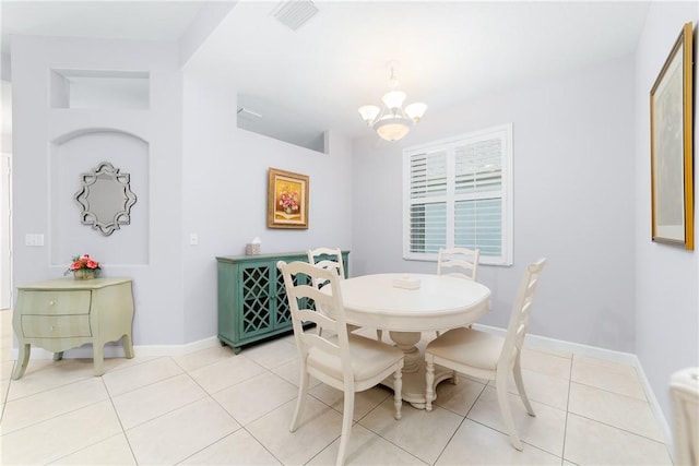 tiled dining room with a notable chandelier