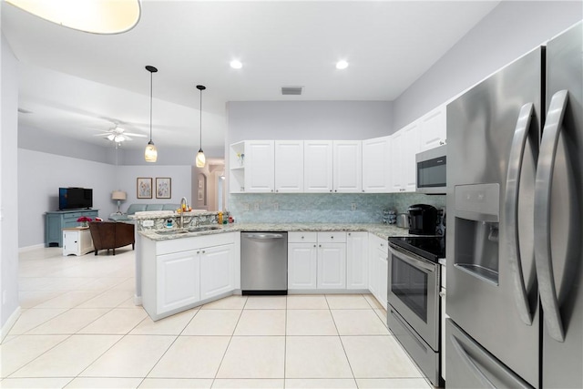 kitchen with white cabinetry, sink, stainless steel appliances, and kitchen peninsula