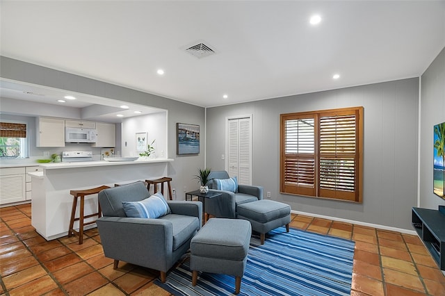 living room featuring tile patterned floors and a wealth of natural light