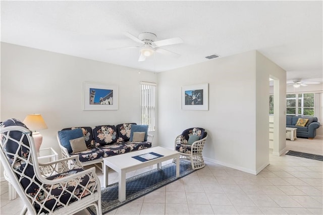 living room with ceiling fan and light tile patterned floors