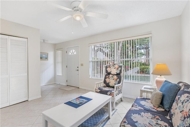 tiled living room featuring ceiling fan