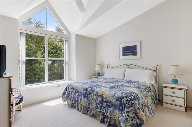 carpeted bedroom featuring multiple windows, vaulted ceiling, and ceiling fan