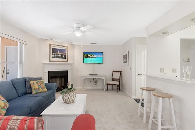 carpeted living room featuring ceiling fan