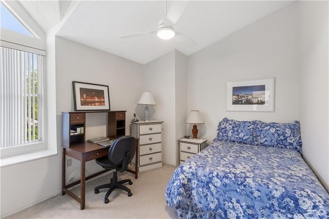 carpeted bedroom featuring a textured ceiling, ceiling fan, and vaulted ceiling