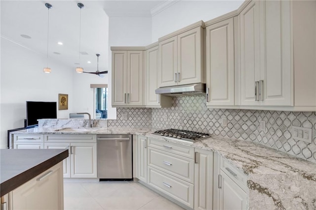 1242 River Reach Dr, Vero Beach, FL 32967 - kitchen with appliances with stainless steel finishes, under cabinet range hood, backsplash, ornamental molding, and pendant lighting