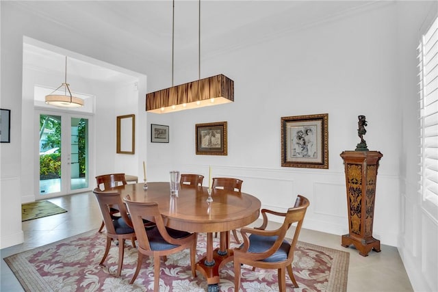 1242 River Reach Dr, Vero Beach, FL 32967 - dining space featuring a decorative wall, a wainscoted wall, and light tile patterned flooring