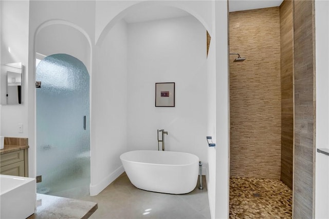 1242 River Reach Dr, Vero Beach, FL 32967 - bathroom with a stall shower, vanity, and a freestanding bath