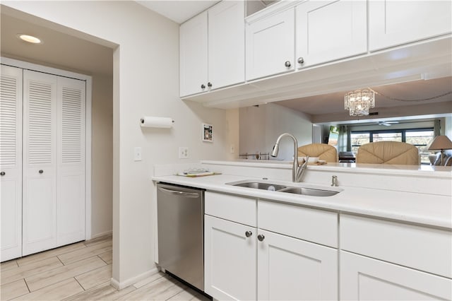 kitchen featuring a sink, white cabinetry, light countertops, wood tiled floor, and dishwasher