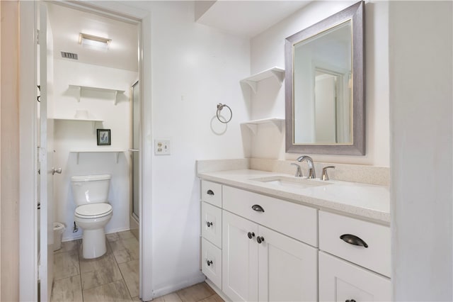 bathroom featuring a shower stall, visible vents, vanity, and toilet